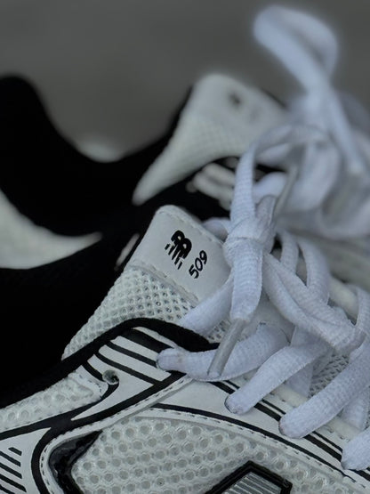 New Balance 509 blanca negra